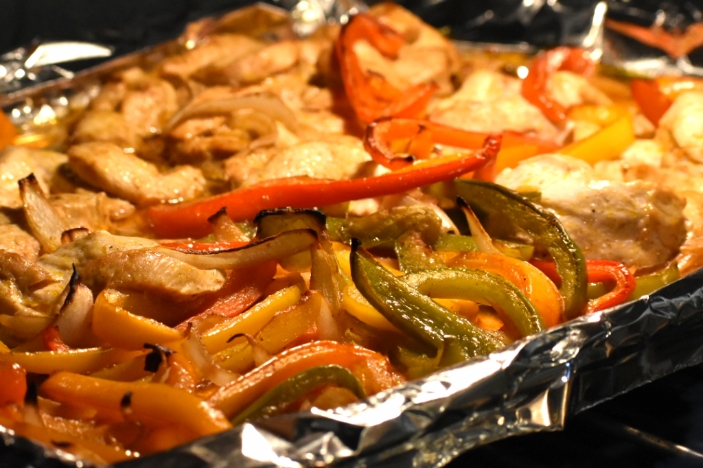 If you need to feed a crowd, this super easy chicken fajita recipe is amazing! Easy clean-up because it all cooks on one sheet pan.